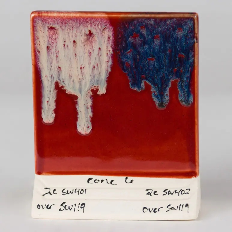 Cinnabar Under SW-401 Light Flux (left) and SW-402 Dark Flux (right), Cone 6